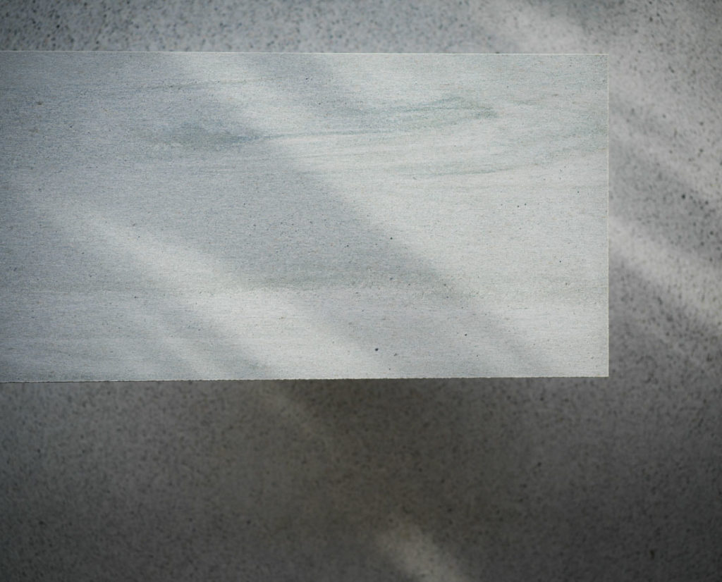 A tile of light Oppdal quartzite slate with a silk brushed surface 