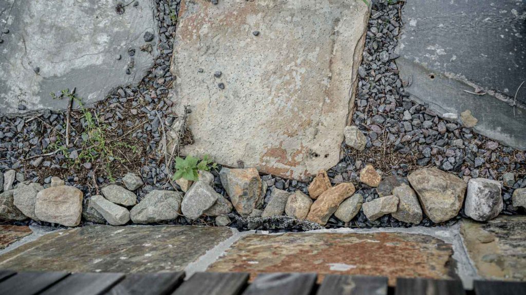 Details of brown golden Otta Pillarguri natural stone on the foundation wall and as a stepping stones.