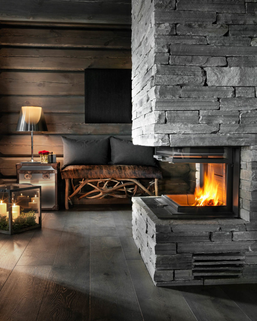 A cabin with a large fireplace drywall in natural stone; Oppdal slate wallbricks.