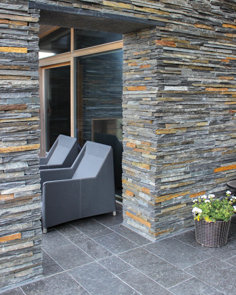 An outdoor terrace with slate of Otta Pillarguri -  bricks for the pergola and outdoor tiles on the terrace floor.