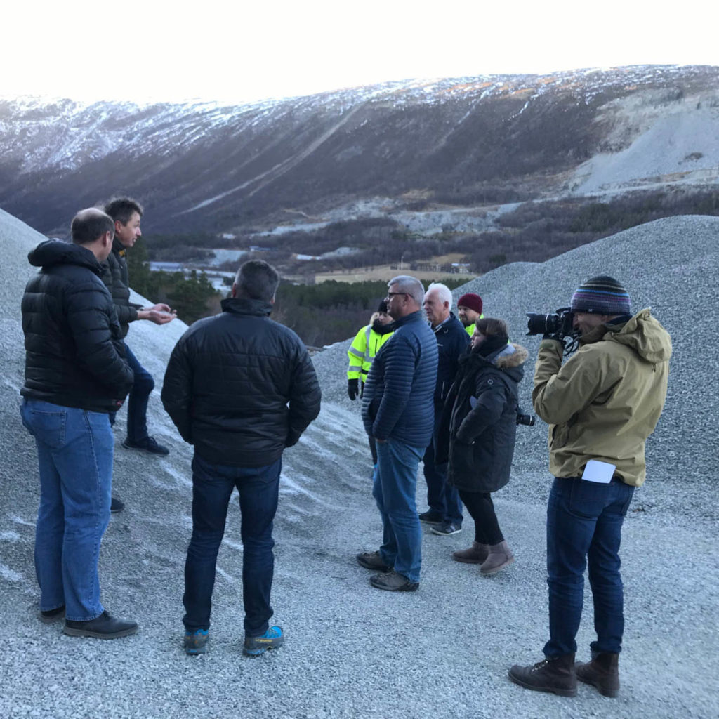A group of people who are researching the sustainable use of slate and reuse is in a slate quarry.