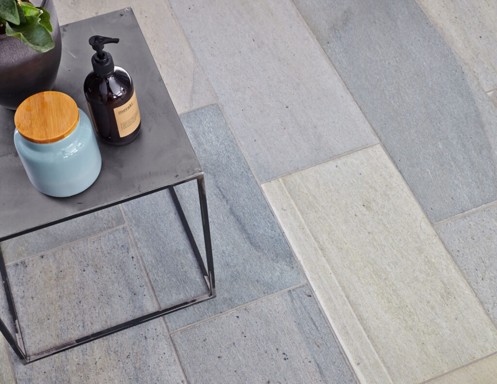 A close-up of a bathroom floor in light grey Oppdal slate tiles